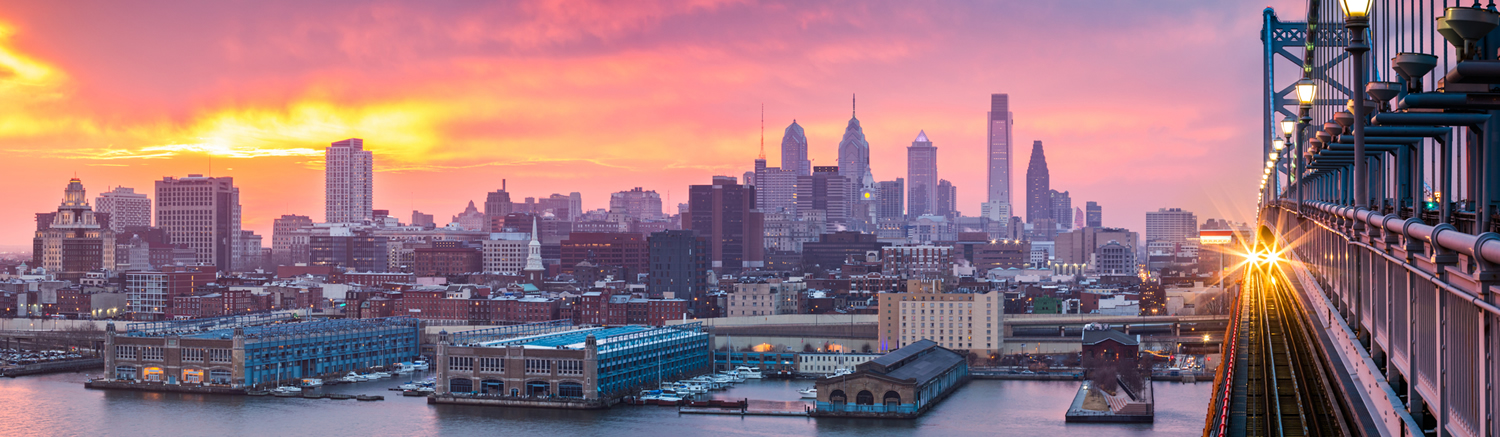 waterfront view of Philadelphia at sunset